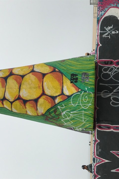 A painted sculpture with graffiti.