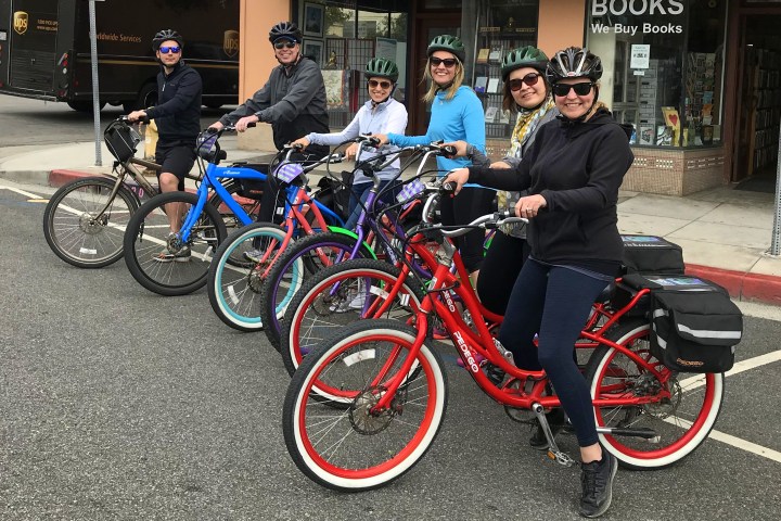 People sitting on electric bikes.